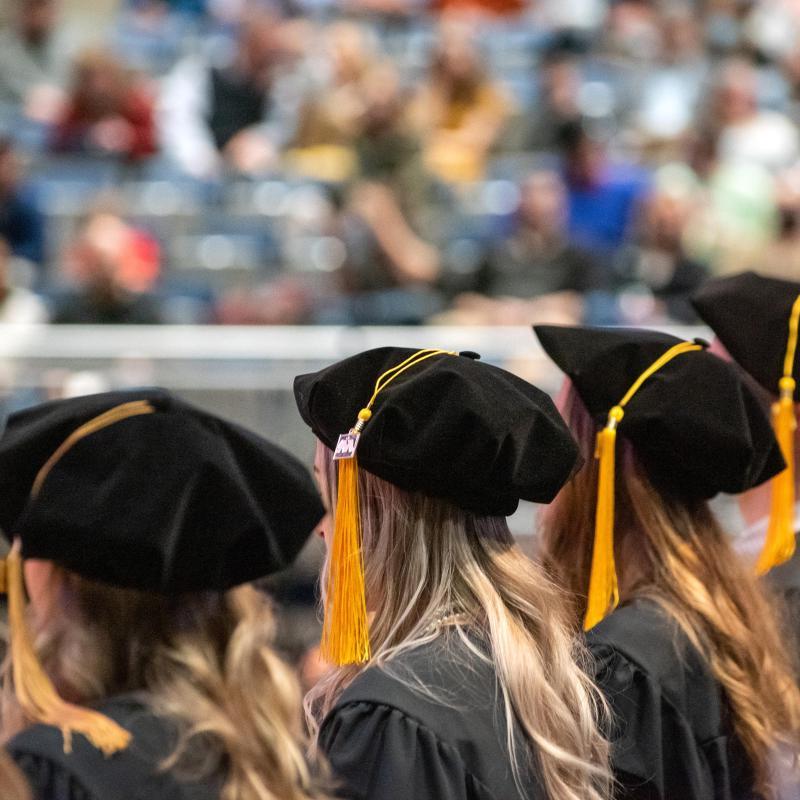 University of Mary graduates sitting at commencement